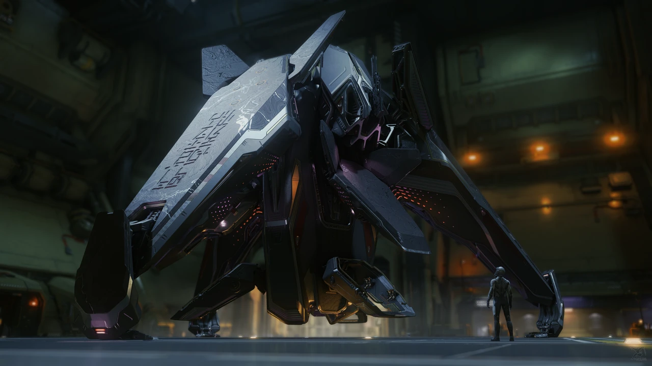 An angular Syulen stands vertically inside a dim hangar beside a person.
